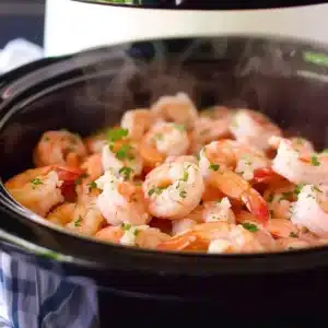 Crock pot steaming as shrimp scampi slow cooks inside